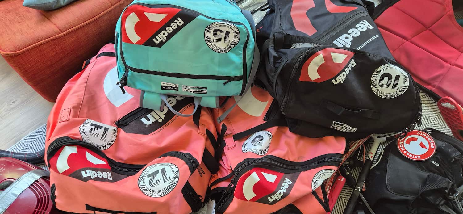 Bulky Reedin kitesurfing backpacks showing the extra weight and volume saved when left at home
